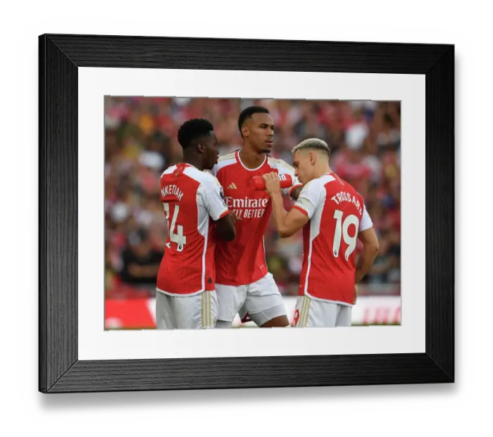 Framed Print : Arsenal's Magalhaes, Ketaih, and Trossard in Action against Manchester City (2023-24)