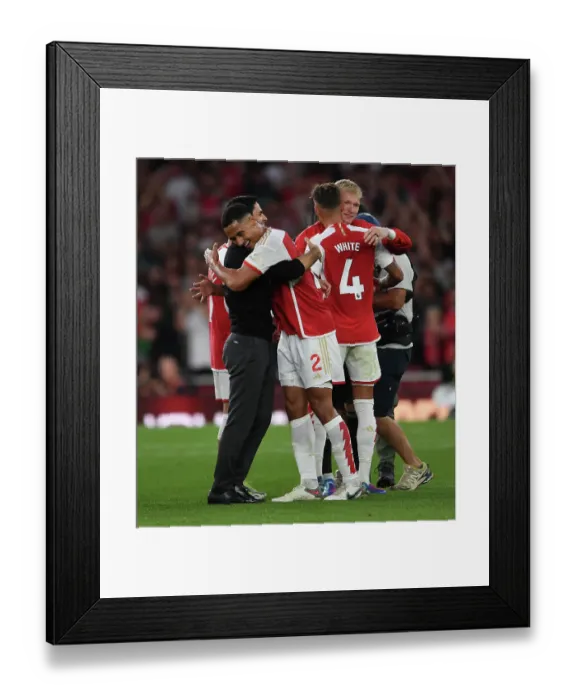 Framed Print : Arsenal's Victory: Mikel Arteta Embraces William Saliba after Beating Manchester City (2023-24)