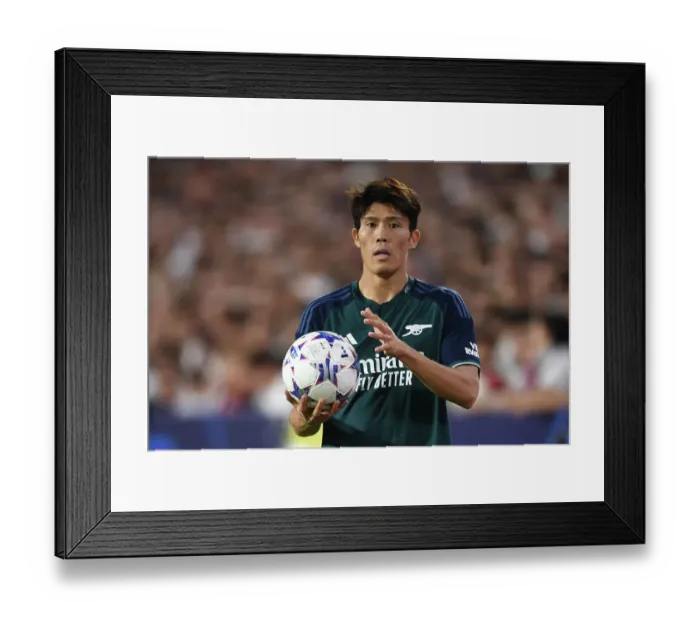 Framed Print : Champions League Showdown: Tomiyasu's Focus - Sevilla vs. Arsenal (2023-24): Arsenal's Japanese Defender Steals the Spotlight at Estadio Ramon Sanchez Pizjuan