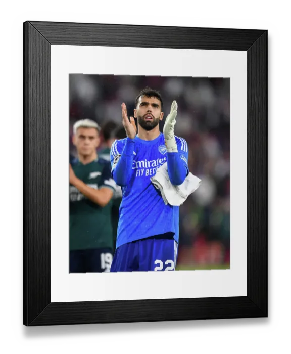 Framed Print : Arsenal's David Raya: Celebrating with Fans after Securing Champions League Victory over Sevilla