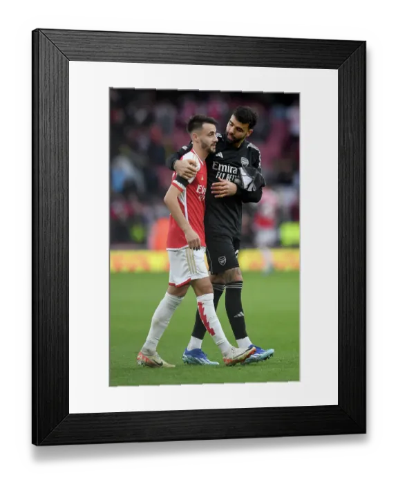 Framed Print : Arsenal's Embrace: Fabio Vieira and David Raya Celebrate Victory Over Sheffield United (2023-24)