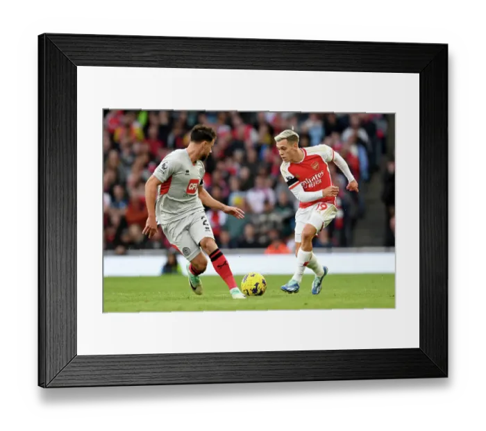 Framed Print : Arsenal's Trossard Outruns Sheffield United's Baldock in 2023-24 Premier League Clash Framed Print : Arsenal's Trossard Outruns Sheffield United's Baldock in 2023-24 Premier League Clash