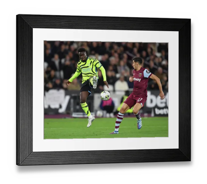 Framed Print : Bukayo Saka Faces Off Against West Ham's Nayef Aguerd in Carabao Cup Clash