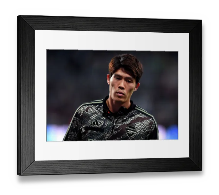 Framed Print : Arsenal's Tomiyasu Gears Up: Newcastle United vs Arsenal, Premier League 2023-24