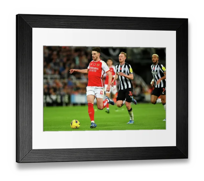Framed Print : Arsenal's Declan Rice Fights Past Newcastle's Sean Longstaff in Premier League Clash