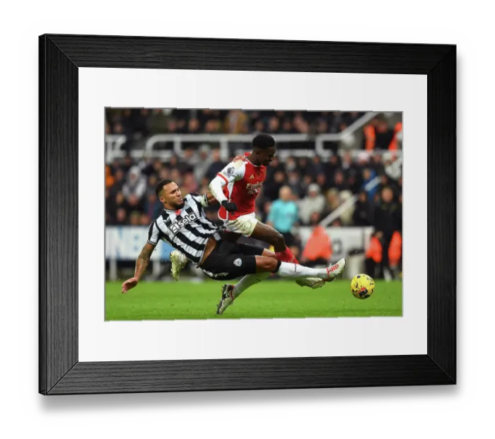Framed Print : Nketiah vs Lascelles: Intense Battle in Newcastle United vs Arsenal FC, Premier League 2023-24