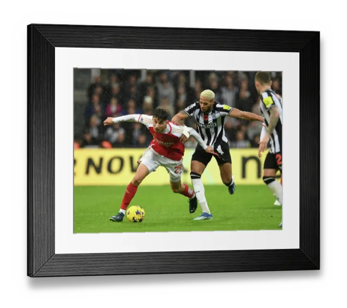 Framed Print : Arsenal's Kai Havertz Faces Off Against Newcastle's Joelinton in Premier League Clash (2023-24)