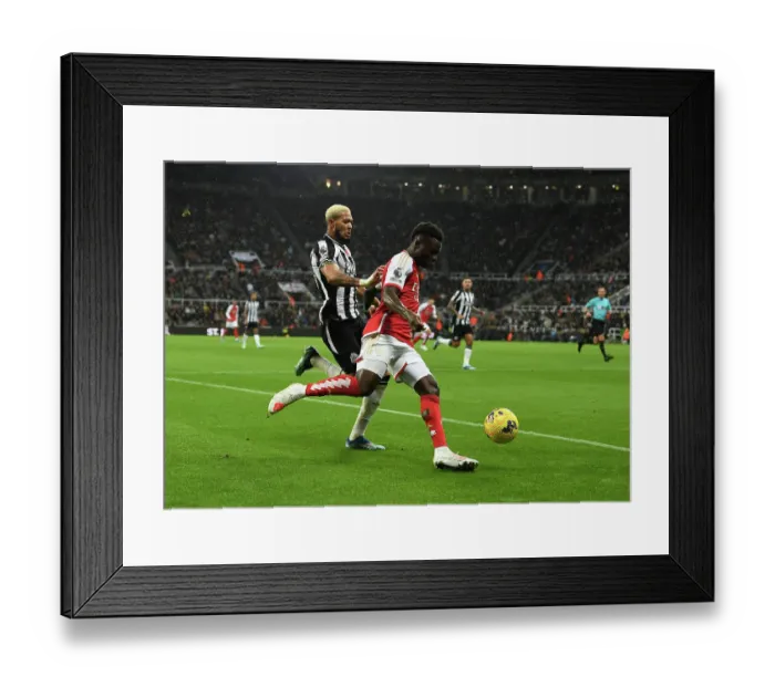 Framed Print : Bukayo Saka vs Joelinton: Intense Battle at St. James Park - Arsenal vs Newcastle United, Premier League 2023-24