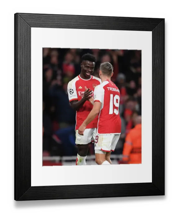 Framed Print : Arsenal's Trossard and Saka Celebrate First Goal Against Sevilla in 2023-24 UEFA Champions League