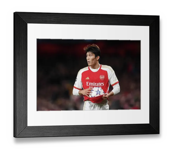 Framed Print : Champions League Showdown: Tomiyasu's Crucial Throw-In at Emirates Stadium (Arsenal vs Sevilla, 2023-24)