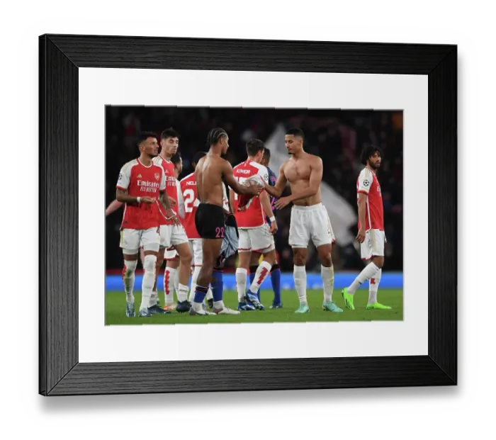 Framed Print : Arsenal's Saliba and Bade Exchange Shirts After Arsenal FC vs Sevilla FC - UEFA Champions League Group Stage 2023 / 24