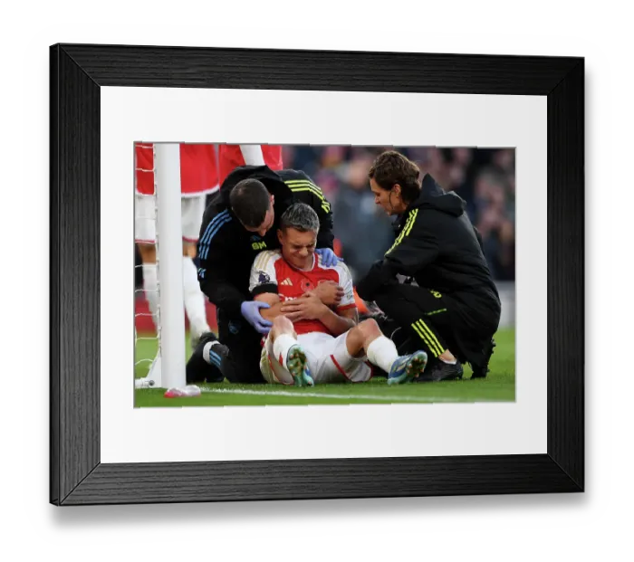 Framed Print : Arsenal's Trossard Scores and Receives Treatment in Thrilling Arsenal v Burnley Clash (2023-24) Framed Print : Arsenal's Trossard Scores and Receives Treatment in Thrilling Arsenal v Burnley Clash (2023-24)