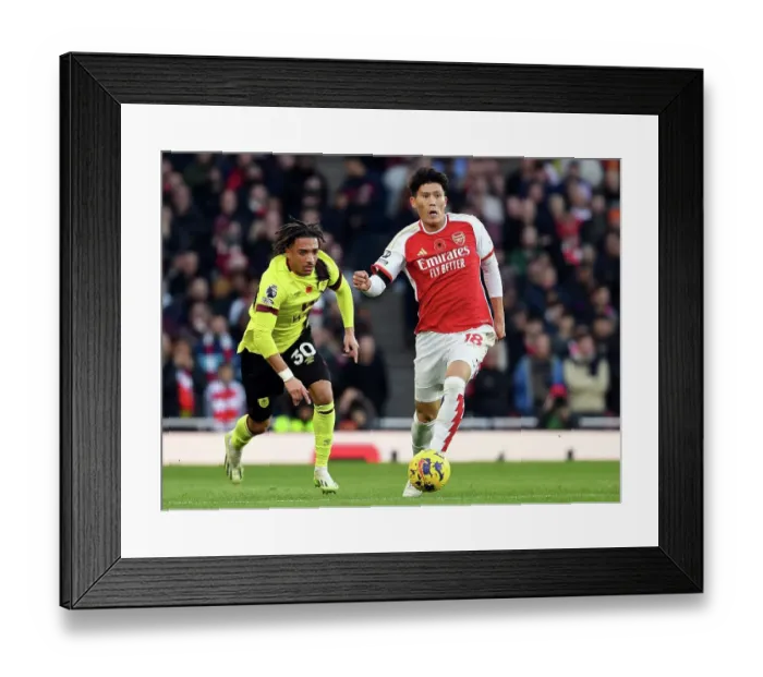 Framed Print : Arsenal's Tomiyasu Fends Off Burnley's Koleosho: Premier League Clash at Emirates Stadium (2023-24)