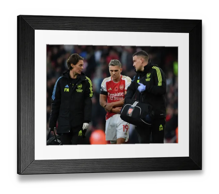 Framed Print : Arsenal's Injured Trossard Tended to by Medical Team During Arsenal v Burnley Match, 2023-24