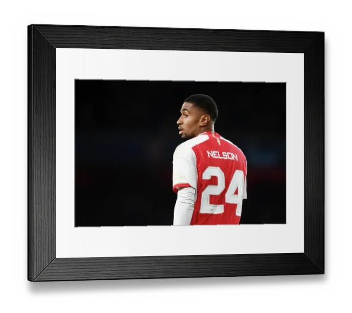Framed Print : Reiss Nelson's Unwavering Concentration: Arsenal vs Sevilla, UEFA Champions League 2023 / 24