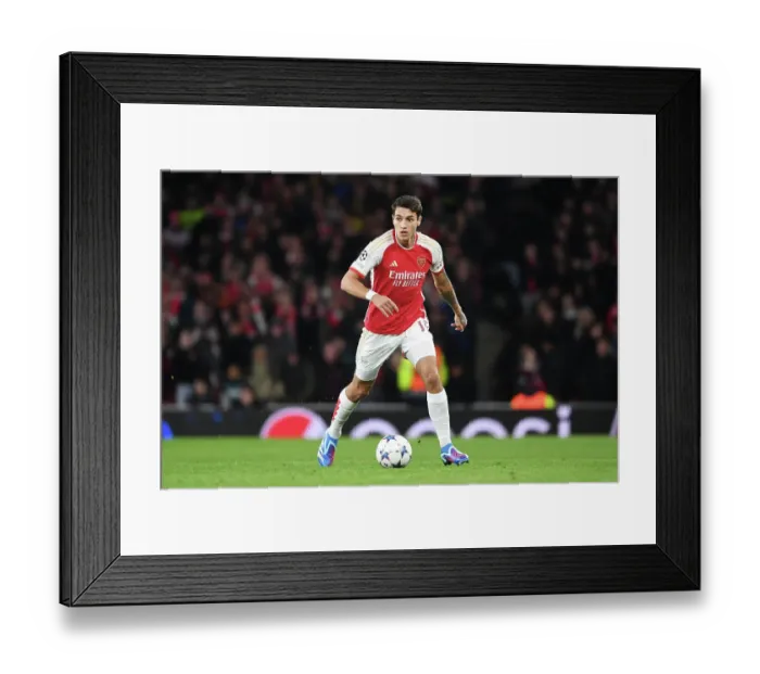 Framed Print : Arsenal's Kiwior Charges Forward in UCL Showdown vs Sevilla at Emirates Stadium Framed Print : Arsenal's Kiwior Charges Forward in UCL Showdown vs Sevilla at Emirates Stadium