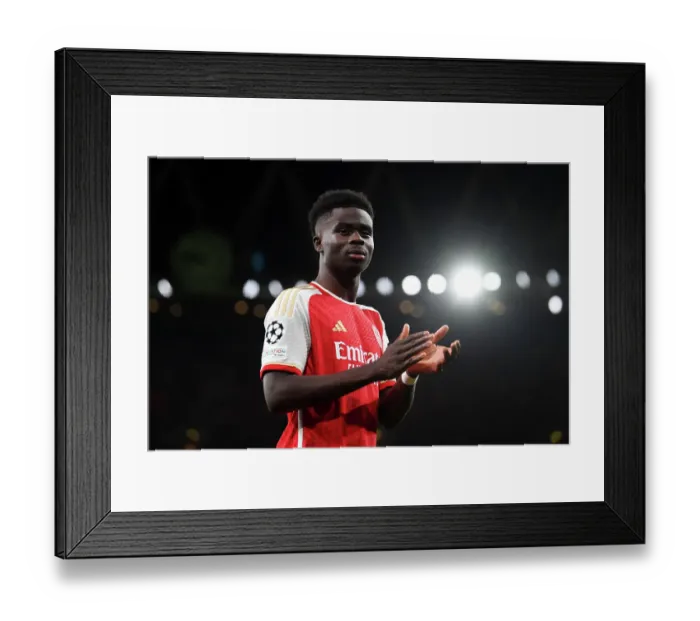 Framed Print : Arsenal's Bukayo Saka Salutes Appreciative Fans after a Hard-Fought UEFA Champions League Match vs Sevilla (2023-24) Framed Print : Arsenal's Bukayo Saka Salutes Appreciative Fans after a Hard-Fought UEFA Champions League Match vs Sevilla (2023-24)