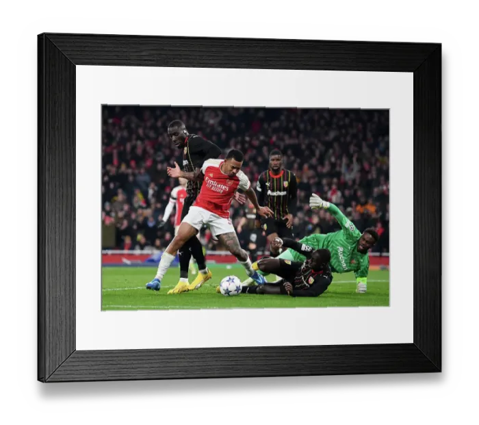 Framed Print : Arsenal's Gabriel Jesus Faces Off Against RC Lens Massadio Haidara in Champions League Group Stage Clash