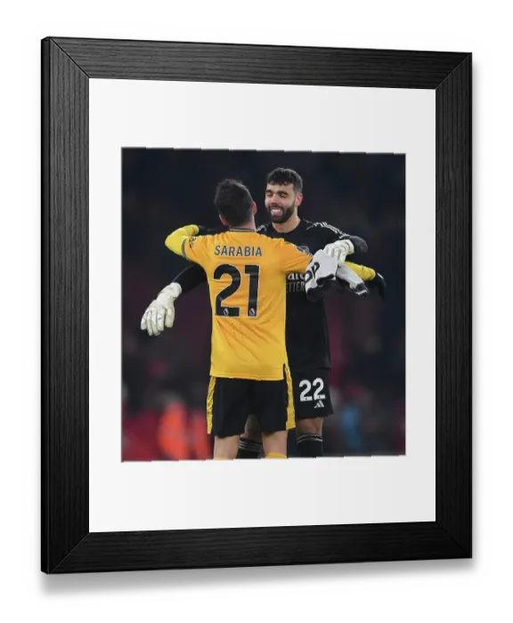 Framed Print : Arsenal's David Raya Embraces Pablo Sarabia After Intense Arsenal v Wolverhampton Wanderers Clash (2023-24)