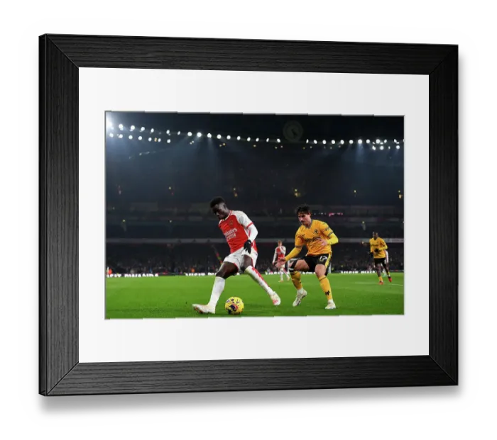 Framed Print : Arsenal's Bukayo Saka Faces Off Against Wolverhampton Wanderers Hugo Bueno in 2023-24 Premier League Clash