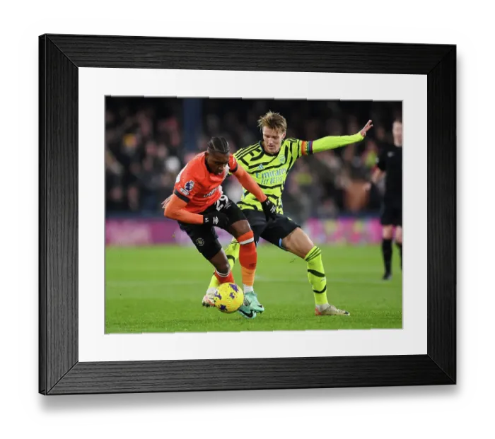 Framed Print : Arsenal's Martin Odegaard Faces Off Against Luton Town's Amari Bell in Premier League Clash (Luton Town vs Arsenal 2023-24)