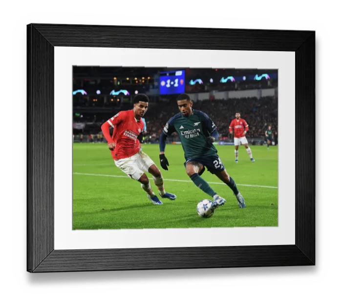 Framed Print : Arsenal's Reiss Nelson Faces Off Against PSV's Malik Tillman in Champions League Clash Framed Print : Arsenal's Reiss Nelson Faces Off Against PSV's Malik Tillman in Champions League Clash
