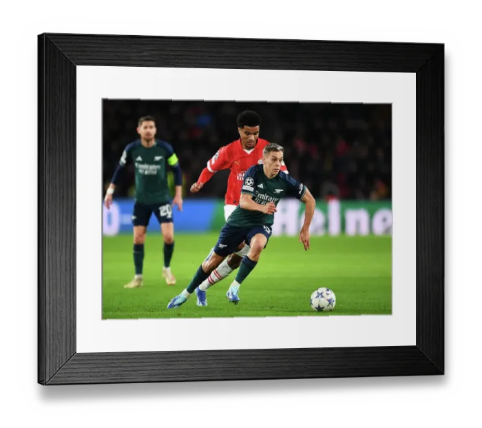 Framed Print : Arsenal's Trossard Clashes with PSV's Tillman in Champions League Battle Framed Print : Arsenal's Trossard Clashes with PSV's Tillman in Champions League Battle
