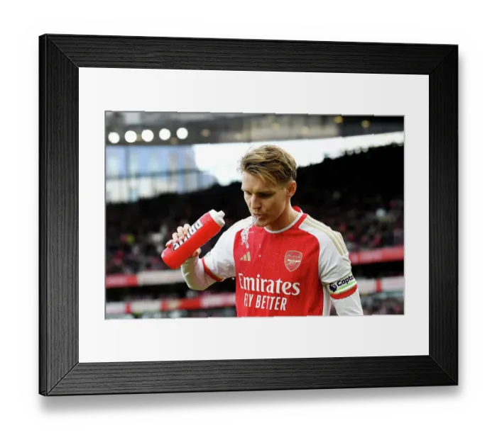 Framed Print : Arsenal's Martin Odegaard Sips Prime Beverage Before Arsenal vs Brighton & Hove Albion (2023-24) Framed Print : Arsenal's Martin Odegaard Sips Prime Beverage Before Arsenal vs Brighton & Hove Albion (2023-24)