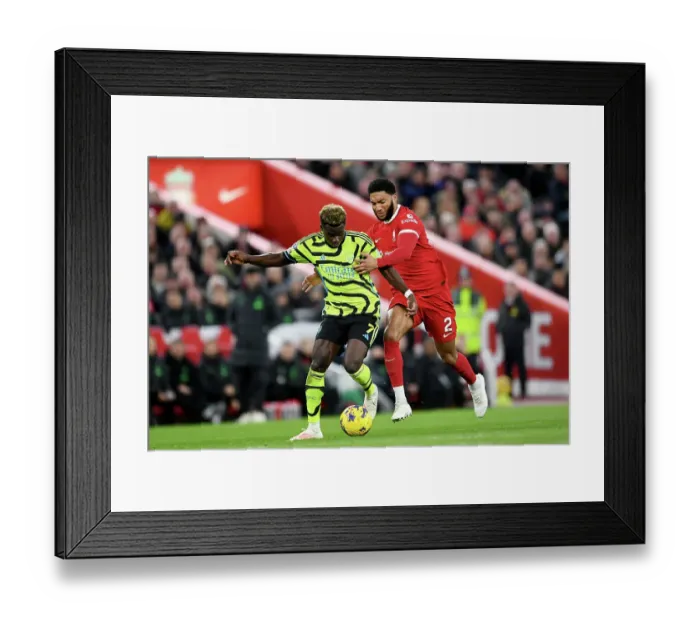Framed Print : Bukayo Saka vs Joe Gomez: Intense Battle at Anfield - Liverpool vs Arsenal, Premier League 2023-24