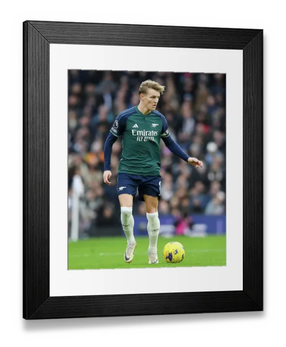 Framed Print : Arsenal's Martin Odegaard Charges Forward in Premier League Clash Against Fulham (2023-24)