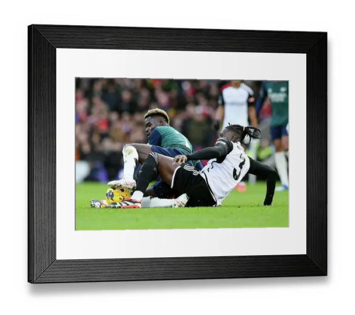 Framed Print : Battling for Possession: Saka vs. Bassey in the Fulham vs. Arsenal Premier League Clash (2023-24)