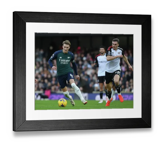 Framed Print : Clash at Craven Cottage: Arsenal's Martin Odegaard Fends Off Fulham's Joao Palhinha Framed Print : Clash at Craven Cottage: Arsenal's Martin Odegaard Fends Off Fulham's Joao Palhinha