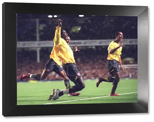 Emmanuel Adebayor celebrates scoring Arsenals goal with Armand Traore