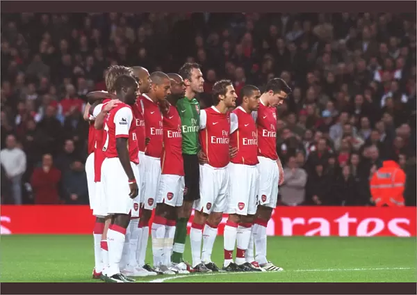 The Arsenal players line up for a minutes silence for Rememberence Day before the match