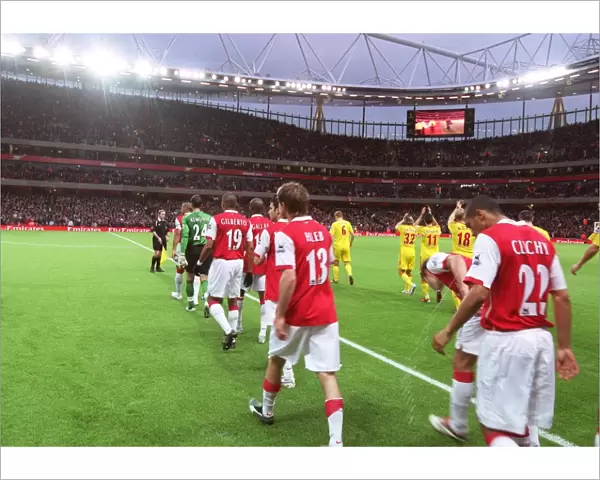 Alex Hleb and Gael Clichy (Arsenal) walk out with the team onto the pitch