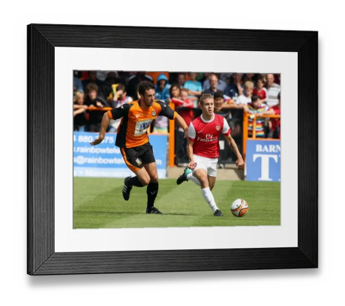 Framed Print : Jack Wilshere (Arsenal) Glenn Poole (Barnet). Barnet 0: 4 Arsenal. Pre Season Friendly Framed Print : Jack Wilshere (Arsenal) Glenn Poole (Barnet). Barnet 0: 4 Arsenal. Pre Season Friendly