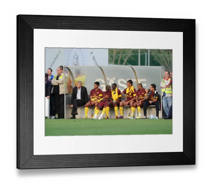 Framed Print : Arsenal manager Arsene Wenger on the bench with substitutes during the match Framed Print : Arsenal manager Arsene Wenger on the bench with substitutes during the match