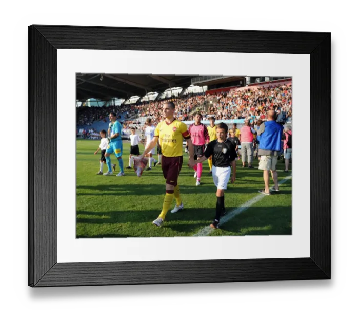 Framed Print : Arsenal captain Thomas Vermaelen leads the team out before the match. Sturm Graz 0