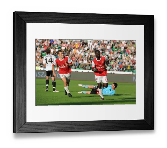 Framed Print : Eboue and Wilshere: Unforgettable Moment as Arsenal Scores the Third Goal Against Legia Warsaw Framed Print : Eboue and Wilshere: Unforgettable Moment as Arsenal Scores the Third Goal Against Legia Warsaw