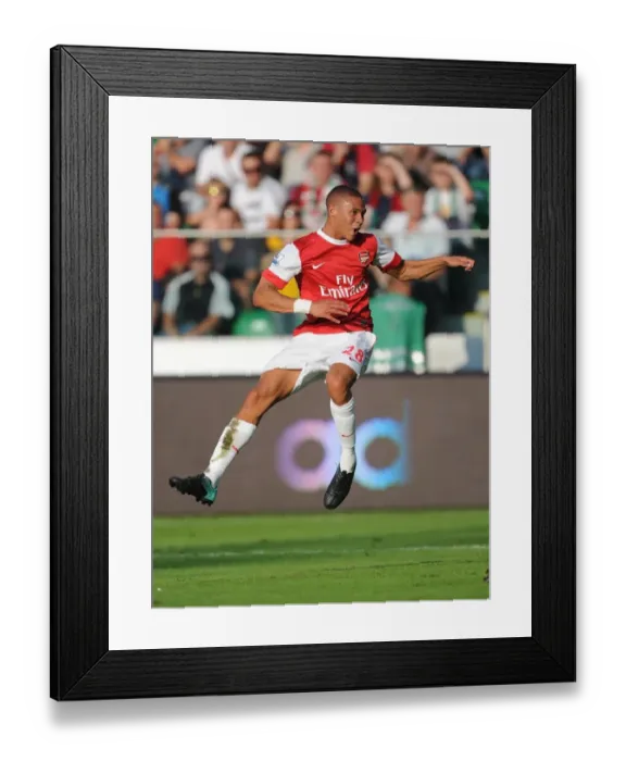 Framed Print : Kieran Gibbs shoots past Liega goalkeeper Kostyantyn Makhnovskyy to score the 4th Arsenal goal
