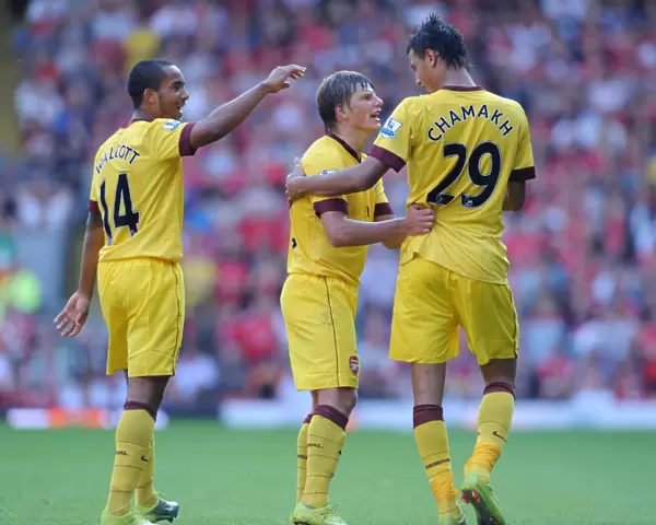 Triumphant Threesome: Chamakh, Arshavin, Walcott Celebrate Arsenal's Goal at Anfield