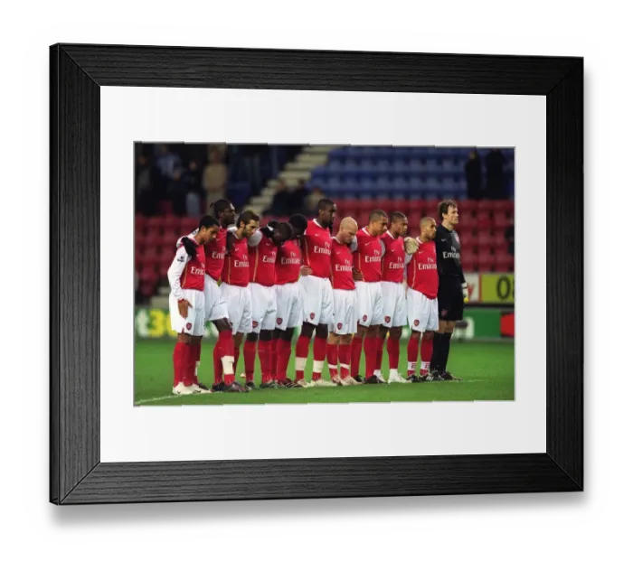 Framed Print : The Arsenal players line up for a minutes silence before the match