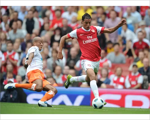 Marouane Chamakh (Arsenal) Alex Baptiste (Blackpool). Arsenal 6: 0 Blackpool