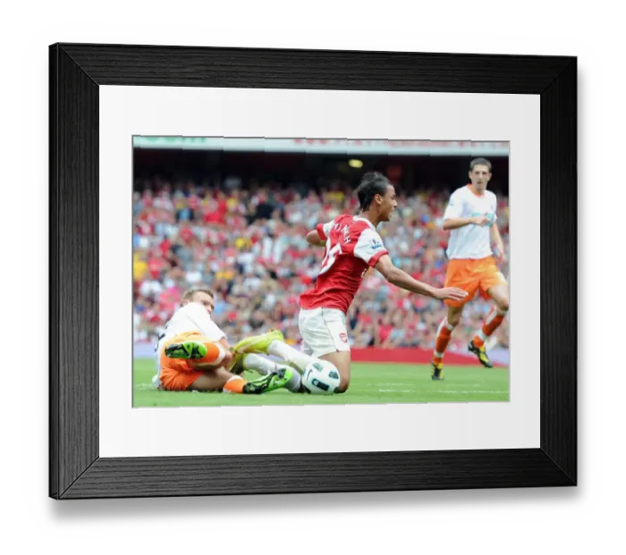 Framed Print : Marouane Chamakh is tripped by Blackpool defender Ian Evatt for the Arsenal penalty