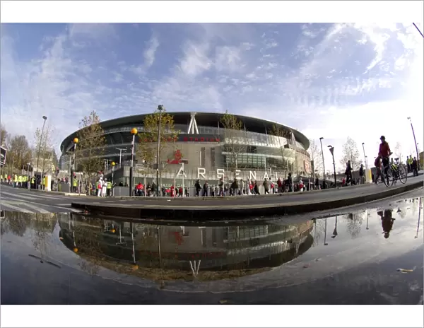 Emirates Stadium reflected in a puddle