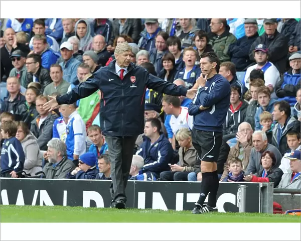 Arsenal manager Arsene Wenger with fourth official Lee Probert. Blackburn Rovers 1