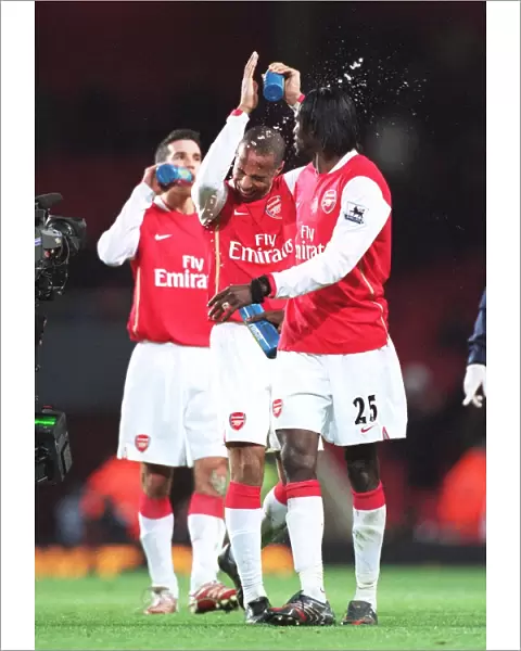 Emmanuel Adebayor squirts water at Thierry Henry (Arsenal) at the end of the match