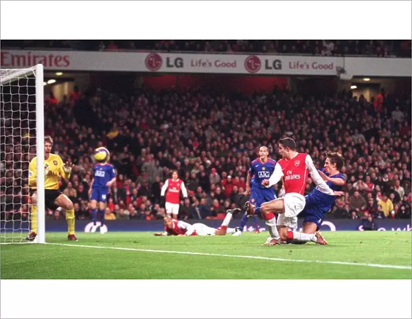 Robin van Persie scores Arsenals 1st goal pass Edwin van der Sar and under pressure from Gary Neville (Man Utd). Arsenal 2: 1 Manchester United. FA Premiership. Emirates Stadium, 21  /  1  /  07. Credit: Arsenal Football Club  / 