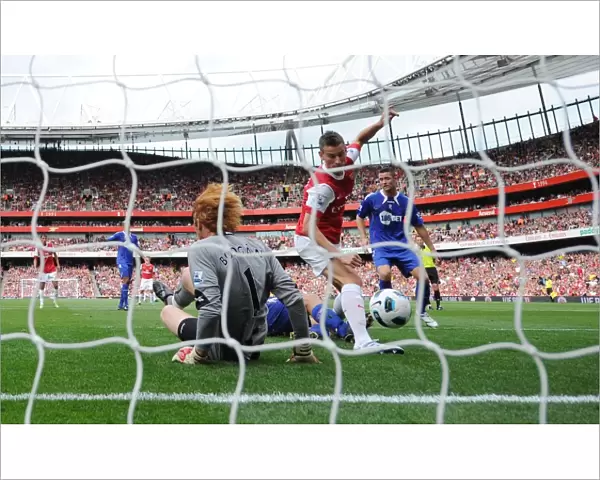 Laurent Koscielny shoots past Bolton goalkeeper Adam Bogdan to score the 1st Arsenal goal