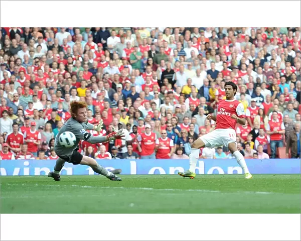 Carlos Vela shoots past Bolton goalkeeper Adam Bogdan to score the 4th Arsenal goal